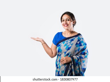 Smiling Attractive Indian Woman in saree Showing Copyspace against white background
