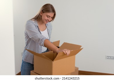 Smiling Attractive Woman Opening Big Carton Box, Feeling Curious Of Unpacking Internet Store Order At Home