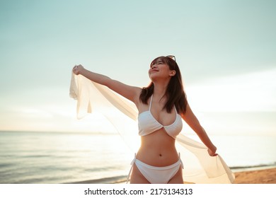 Smiling Attractive Young Asian Woman Bikini Sexy With Shawl On A Seaside Beach Tropical Resting And Relaxation Travel Lifestyle, Happy Female Enjoy Life Playing And Freedom At Sunset.