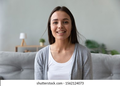 Smiling attractive young lady blogger talking to camera recording blog vlog, happy pretty woman looking at webcam making video conference call online chat distant job interview at home, web cam view - Shutterstock ID 1562124073