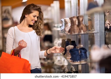 Smiling Attractive Young Women Shopping At Shoes Store