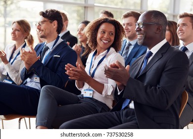 Smiling audience applauding at a business seminar - Shutterstock ID 737530258