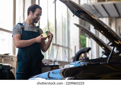 Smiling Automotive Service Technician In His Workplace