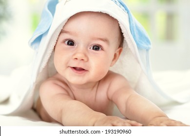 Smiling Baby After Shower With Towel On Head