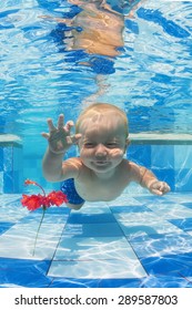 Smiling Baby Boy Diving Underwater With Fun For Red Flower In Blue Pool Active Lifestyle, Child Swimming Lesson With Parents, And Water Sports Activity During Family Summer Vacation In Tropical Resort