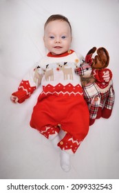 Smiling Baby Boy Dressed In Red Christmas Outfit.  Baby Boy Dressed In Red Christmas Outfit. 