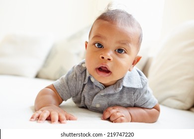 Smiling Baby Boy Lying On Tummy At Home