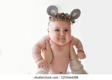 Smiling  Baby Girl In Wearing Mouse Ears Hat In Mother Hands