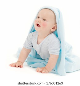 A Smiling Baby Lifting Up With A Blanket Draped Over His Head.