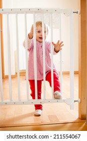 Smiling Baby Near Safety Gate Of  Stairs