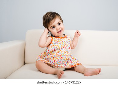 Smiling baby talks and looks away