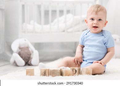 Smiling Baby With Toys On The Carpet In My Room