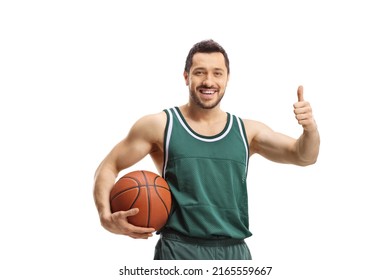 Smiling basketball player holding a ball and showing thumbs up isolated on white background