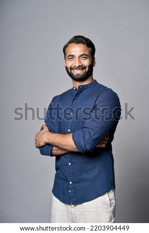 Smiling bearded indian business man investor, happy ethnic ceo, corporate executive, professional lawyer, successful rich banker, male office employee or salesman isolated on gray, vertical portrait.