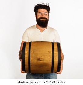 Smiling bearded man with barrel or keg of whiskey, wine or beer. Handsome man with oak barrel or cask of beer. Beer for pub or bar. Brewer carrying wooden barrel with craft beer. Oktoberfest festival. - Powered by Shutterstock