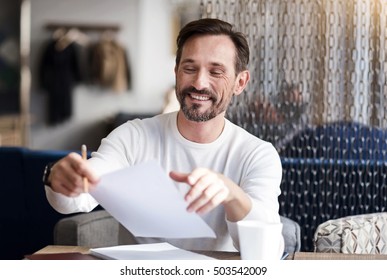 Smiling Bearded Man Holding Paper