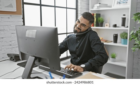 A smiling bearded man multitasking in a modern office setting, conveying professionalism and approachability.