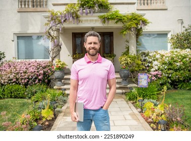 smiling bearded man selling or renting house on pc online, homeowners insurance - Shutterstock ID 2251890249