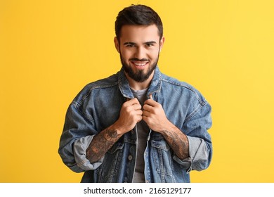 Smiling Bearded Man Wearing Denim Jacket On Yellow Background