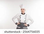 smiling beautiful Asian woman chef puts hands on her hips in complete chef