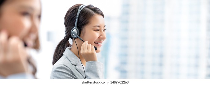 Smiling Beautiful Asian Woman Working In Call Center Office As A Telemarketer