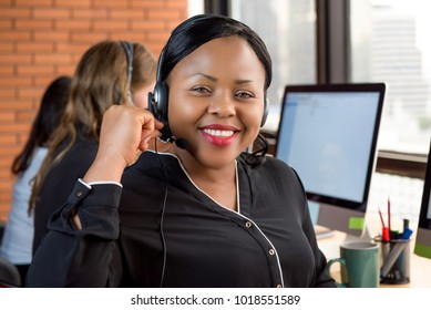 Smiling Beautiful Black Businesswoman Working In Call Center As A Customer Service Agent With Her Multiethnic Team