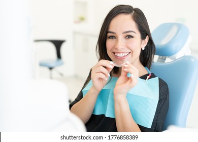 Smiling Beautiful Caucasian Mid Adult Woman Holding Invisible Orthodontic Retainer