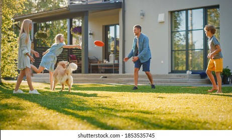 Smiling Beautiful Family of Four Play Fetch flying disc with Happy Golden Retriever Dog on the Backyard Lawn. Idyllic Family Has Fun with Loyal Pedigree Dog Outdoors in Summer House Backyard - Shutterstock ID 1853535745
