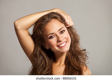 Smiling beautiful girl with a hand in her hair