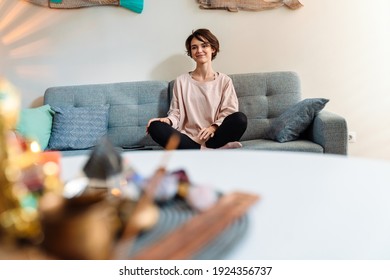 Smiling Beautiful Girl Sitting On Couch At Home Shrine Indoors