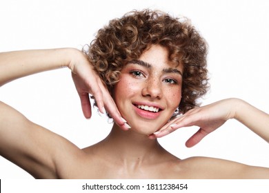 Smiling beautiful healthy freckled girl with curly hair