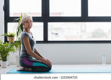 Smiling Beautiful Senior Woman Yoga Instructor. Yoga Classes For Seniors .