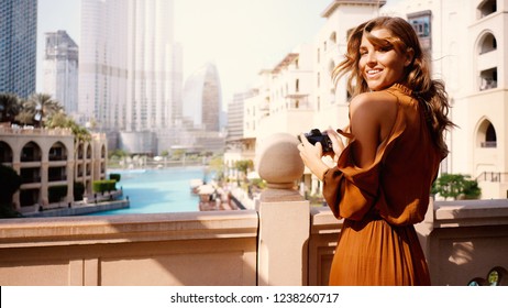 Smiling Beautiful Tourist Woman Portrait With Camera In Dubai.