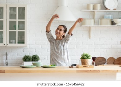 Smiling Beautiful Woman Dancing In Modern Kitchen, Preparing Healthy Food Alone, Cooking Salad, Carefree Happy Girl Singing And Moving To Favorite Music, Having Fun At Home, Enjoying Leisure Time