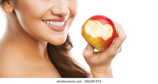 Smiling beautiful woman holding red apple while isolated on white