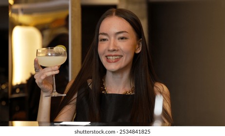 Smiling beautiful woman zipping Margarita cocktail savoring tasty drink making special time by bartender at luxurious bar creating moment meeting with friends or a couple vibrant nightclub. Vinosity. - Powered by Shutterstock