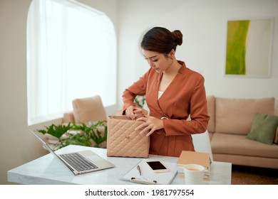 Smiling Beautiful Young Business Woman Holding One Open Pink Leather Handbag Putting Water Bottle Inside 