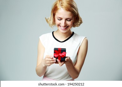 Smiling Beautiful Young Woman Holding An Open Jewelery Gift Box