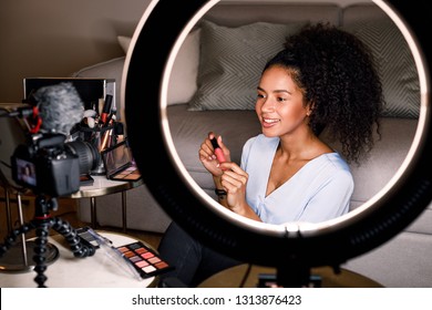 Smiling Beauty Vlogger Recording Video For Her Channel Using Ring Light And Digital Camera