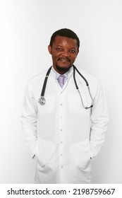 Smiling Black Bearded Doctor Man In White Coat With Stethoscope Isolated On White Background. Friendly Adult Black African American Physician Therapist Portrait, Pleasant Candid Male Emotion