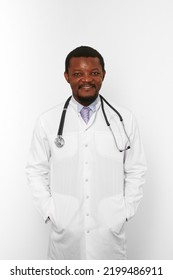 Smiling Black Bearded Doctor Man In White Coat With Stethoscope Isolated On White Background. Friendly Adult Black African American Physician Therapist Portrait, Pleasant Candid Male Emotion