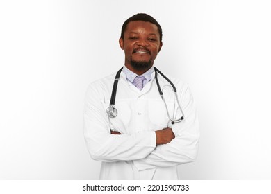 Smiling Black Bearded Doctor Man Crossed Arms In White Robe With Stethoscope Isolated On White Background. Adult Black African American Physician Therapist Portrait, Confident Candid Male Emotion