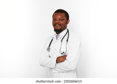 Smiling Black Bearded Doctor Man Crossed Arms In White Robe With Stethoscope Isolated On White Background. Adult Black African American Physician Therapist Portrait, Confident Candid Male Emotion