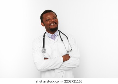 Smiling Black Bearded Doctor Man Crossed Arms In White Coat With Stethoscope Isolated On White Background. Adult Black African American Physician Therapist Portrait, Confident Candid Male Emotion