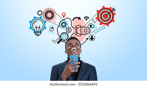 Smiling black businessman using smartphone, drawing of gears, rocket and target on blue background. Process of thinking icons. Concept of goal and opportunities - Powered by Shutterstock