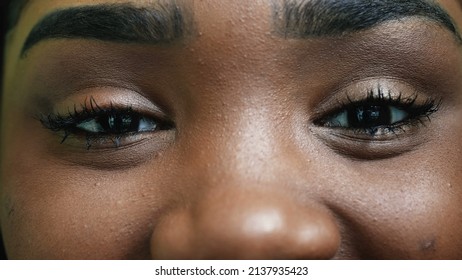 A smiling black latina hispanic girl macro eyes close-up
