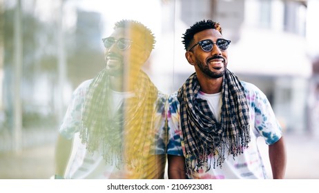 Smiling Black Man Leaning Against Glass Wall