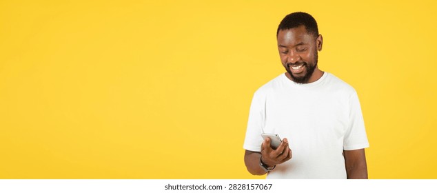 Smiling Black Man Using Smartphone On Yellow Background, Technology Concept