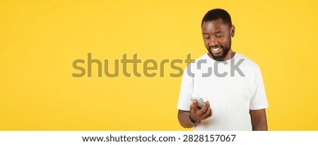 Smiling Black Man Using Smartphone On Yellow Background, Technology Concept