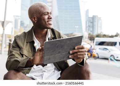 Smiling Black Man Using Tablet Outdoor